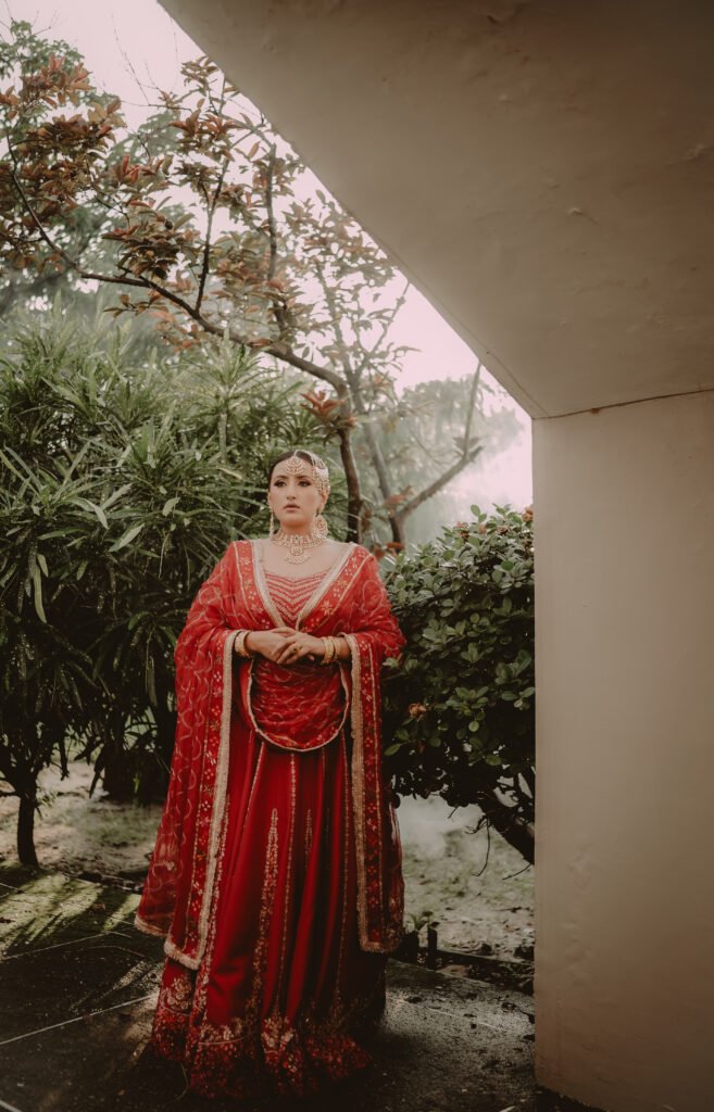 Bride in a red lehenga, wedding portrait by Immortal Stories